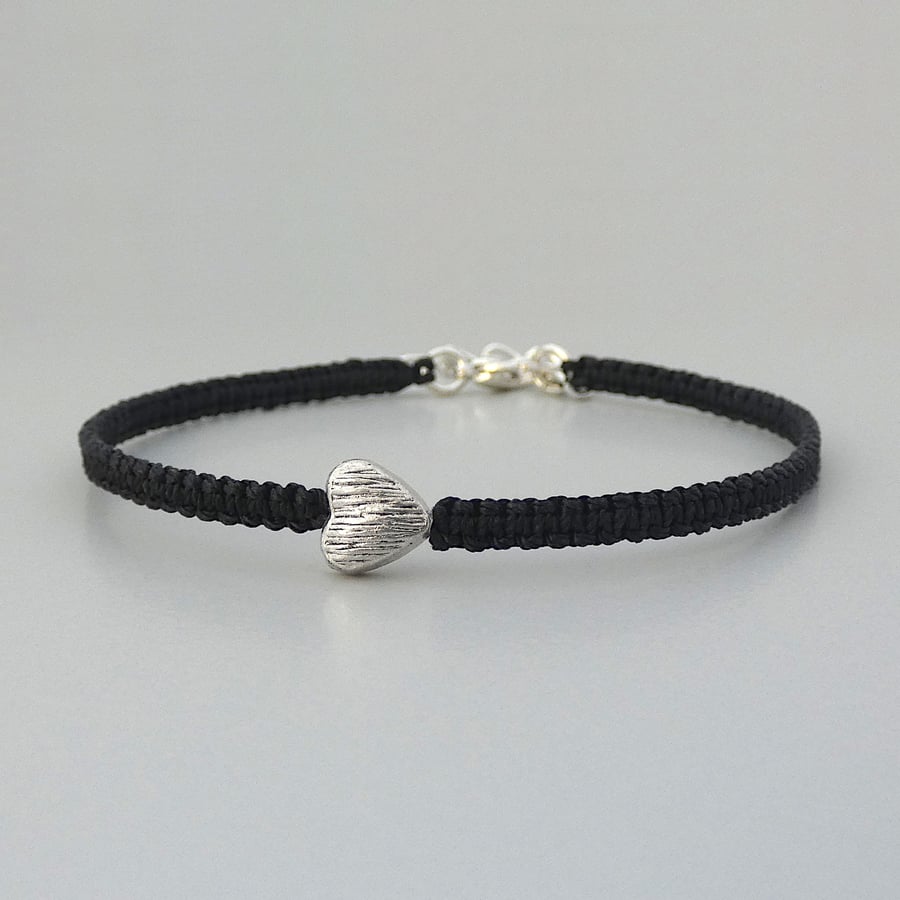 Black 7" macramé bracelet with silver plated heart charm and 1” extender chain.