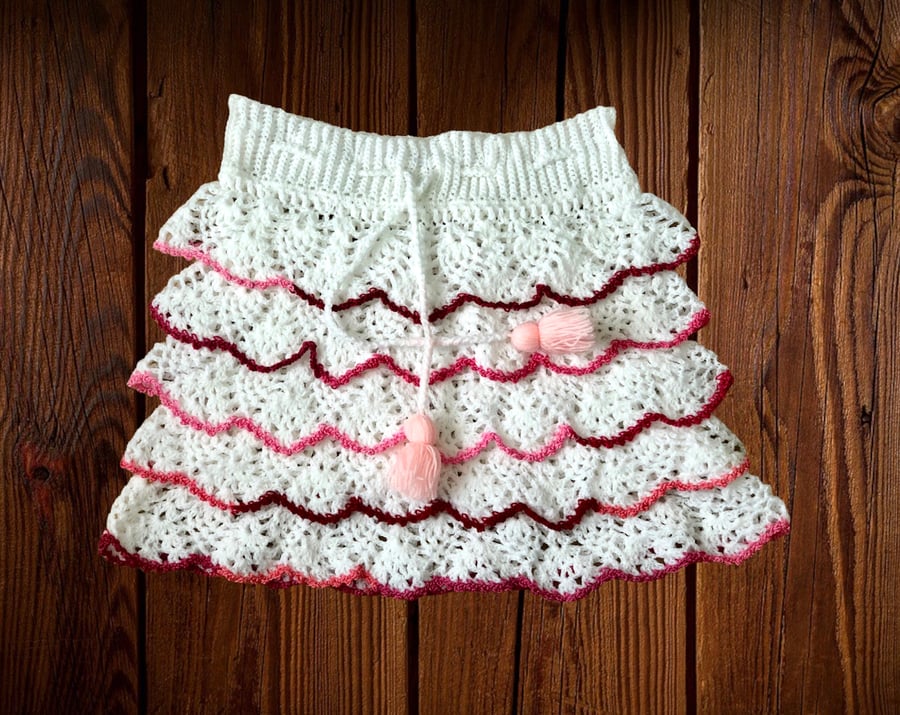 Ruffle crochet mini skirt. White with various shades of pink. Size U.K. small S.