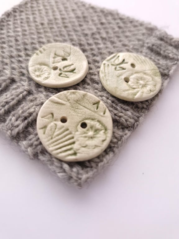 Nature buttons, ceramic buttons embossed with natural elements, coloured green. 