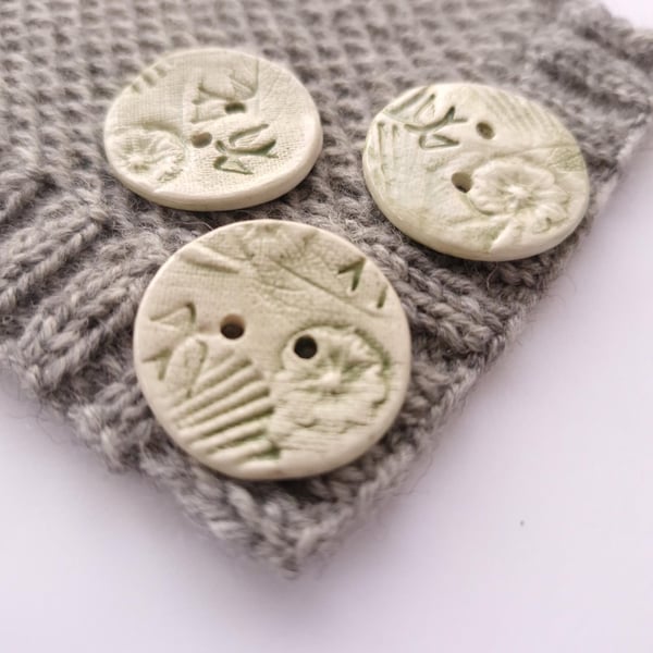 Nature buttons, ceramic buttons embossed with natural elements, coloured green. 