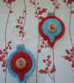 Pair of bauble shaped felt handstitched red and blue Christmas decorations - Image 1