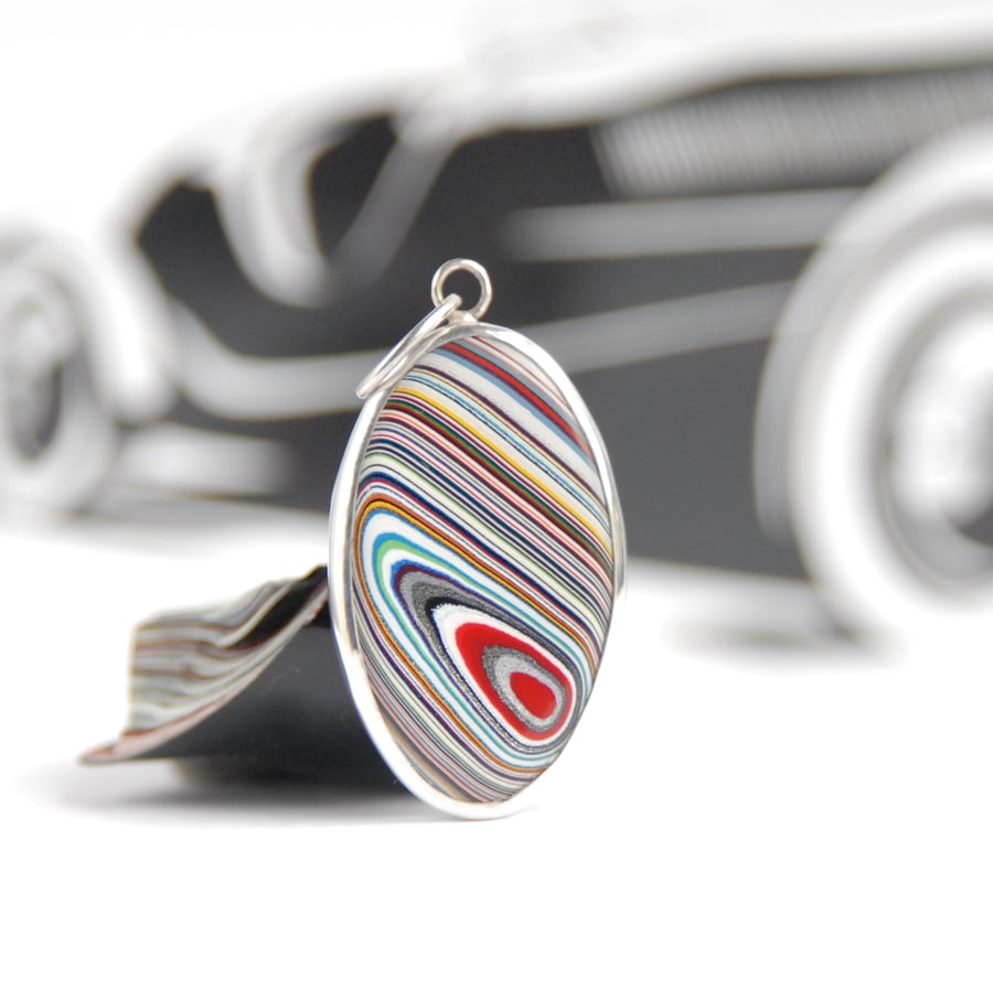Oval Kenworth fordite pendant (red and silver eye)