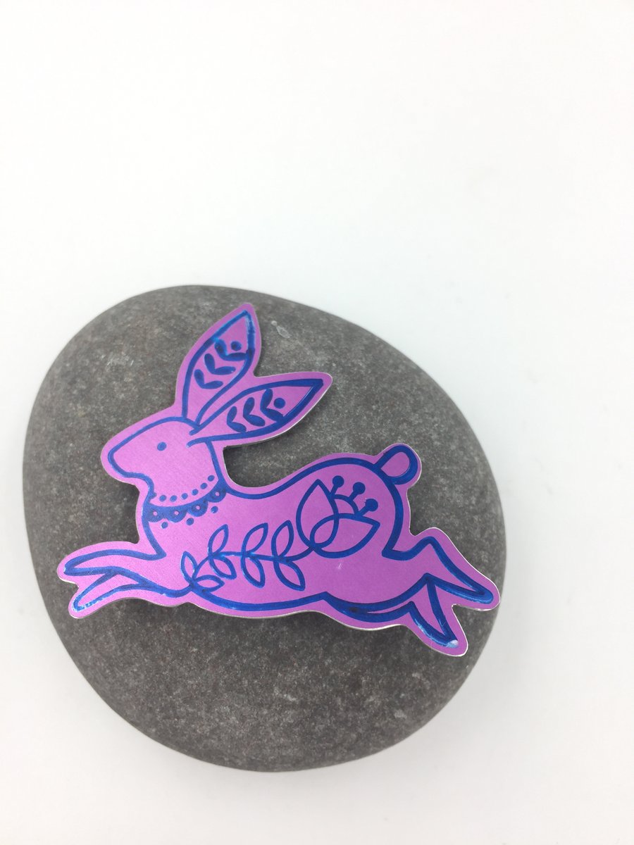 Pink anodised aluminium rabbit brooch.