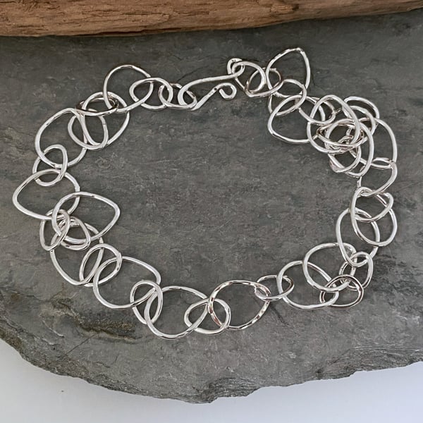 Chunky silver chain necklace made from raindrop shaped links 