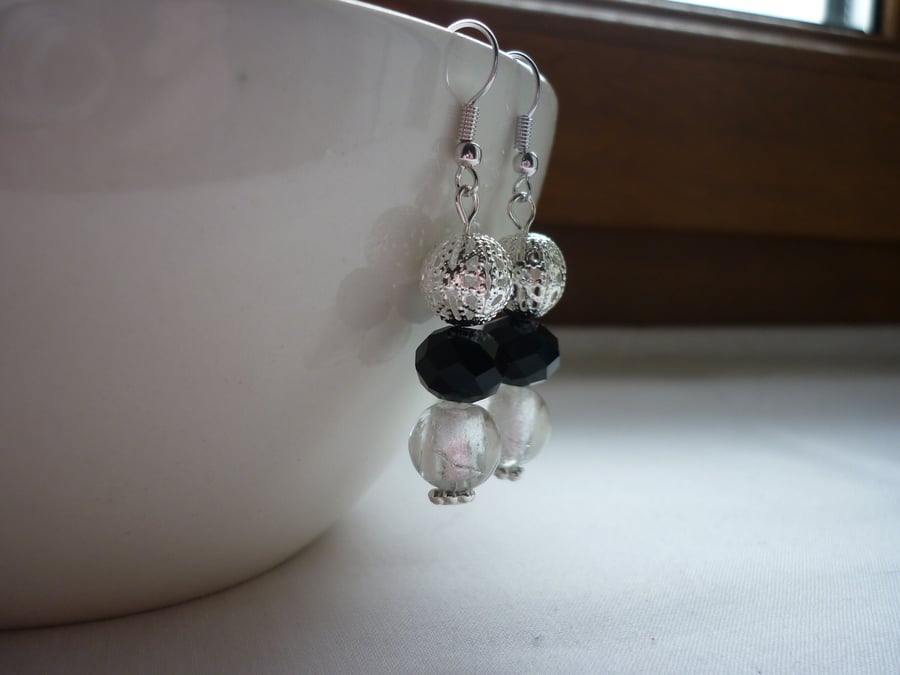 BLACK, CRYSTAL AND SILVER EARRINGS.  889
