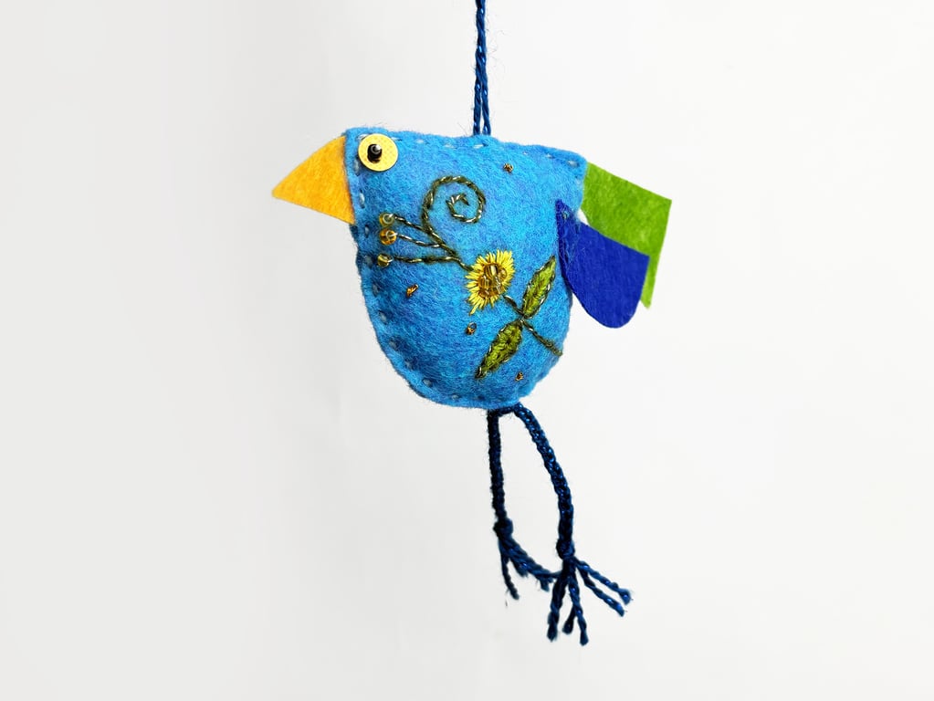 Blue coloured felt bird with hand embroidered body