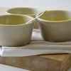 Three yellow swirled hand thrown stoneware dishes - glazed in transparent