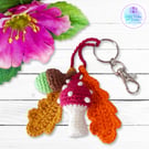 Red toadstool, acorn and oak leaves crochet bag charm. Toadstool keyring