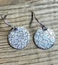 Circular silver earrings with embossed flower pattern - Image 2