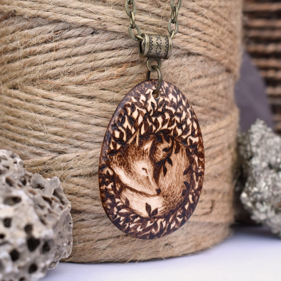 Sleepy fox cub in the leaves. Pyrography wooden pendant necklace.
