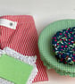 Sustainable kitchen gift set. Five items in red, blue and green