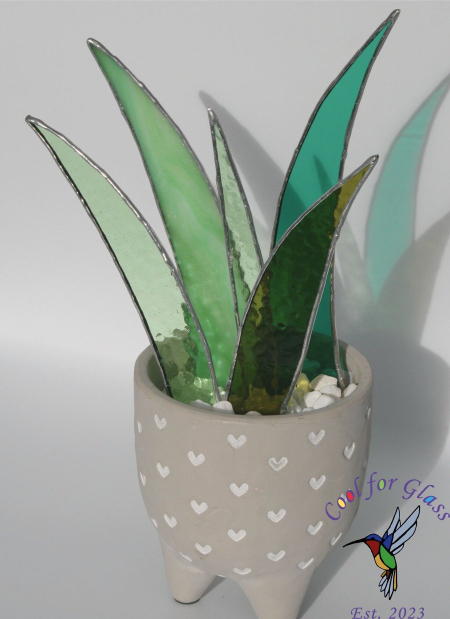 Stained glass aloe vera plant in a decorative pot with small hearts