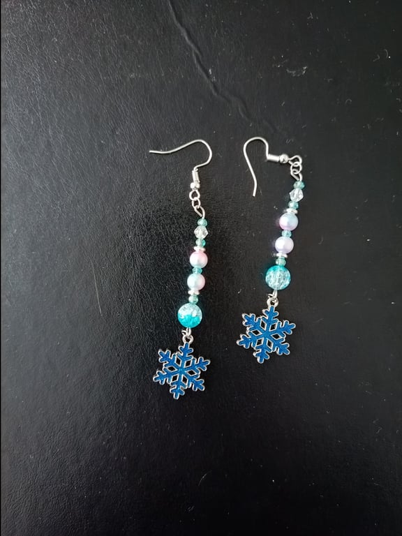 Beaded wintry pastel dangle earrings with blue snowflake charms 