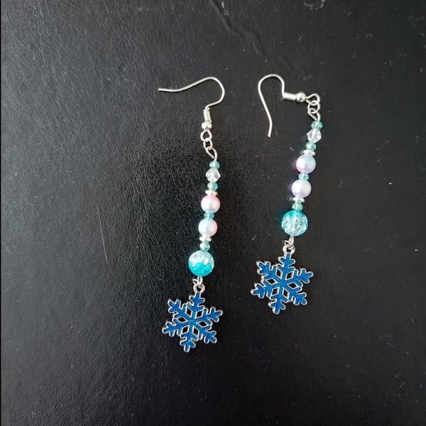 Beaded wintry pastel dangle earrings with blue snowflake charms 