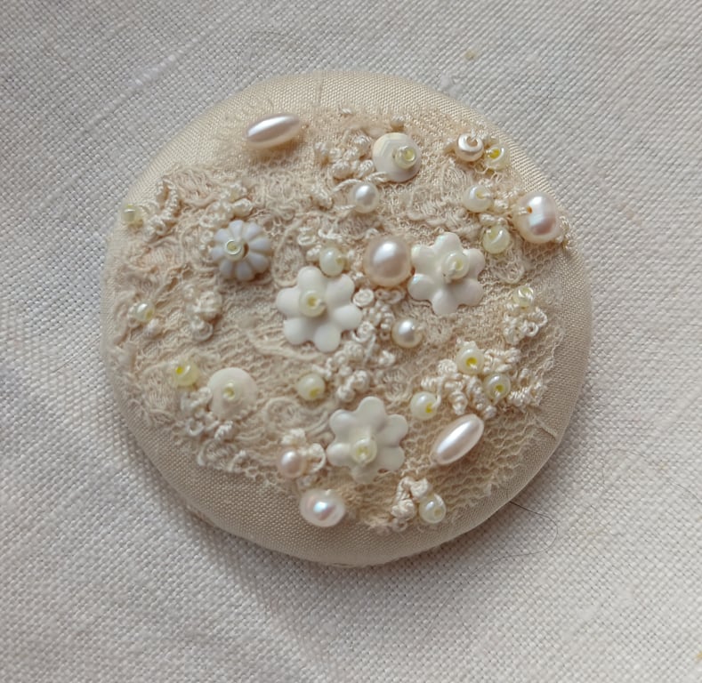 The cream brooch with lace, beads and sequins and lots of french knots