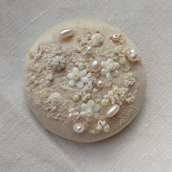 The cream brooch with lace, beads and sequins and lots of french knots