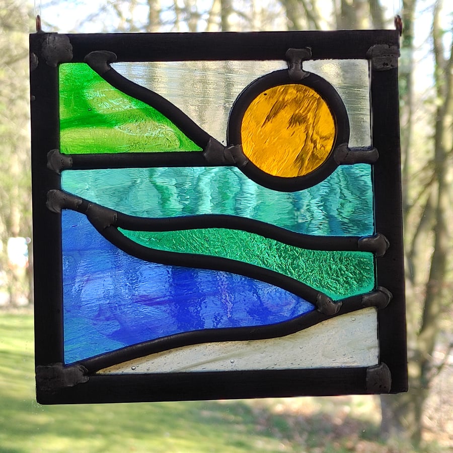 SOLD Sunshine seascape stained glass leaded hanging panel.