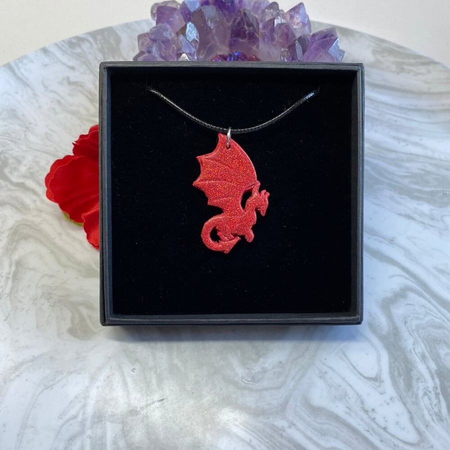 Red dragon glitter necklace made from polymer clay and resin.