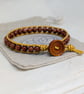 Goldstone and metallic gold leather bracelet with wooden button fastener  - Image 1