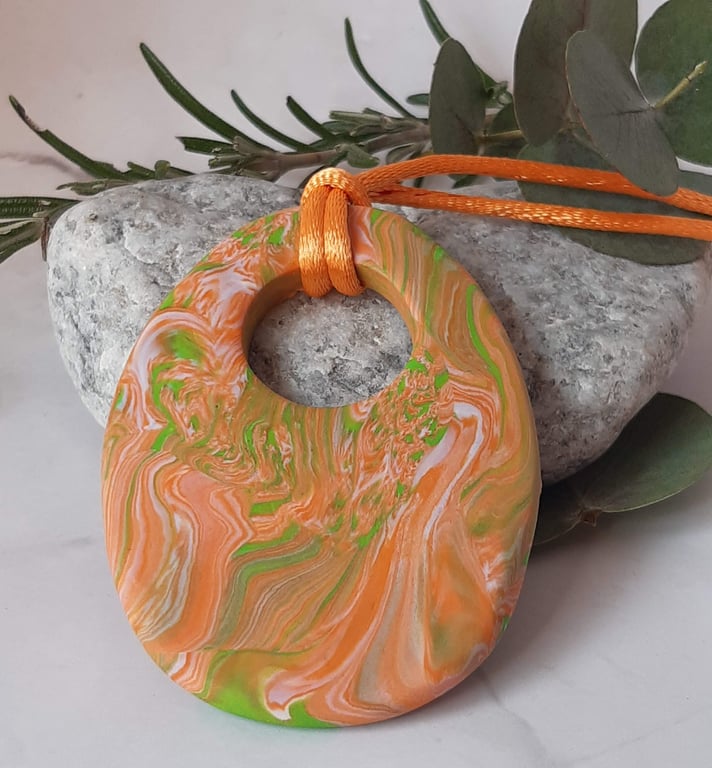 Large handmade oval pendant in orange, peach and lime green polymer clay