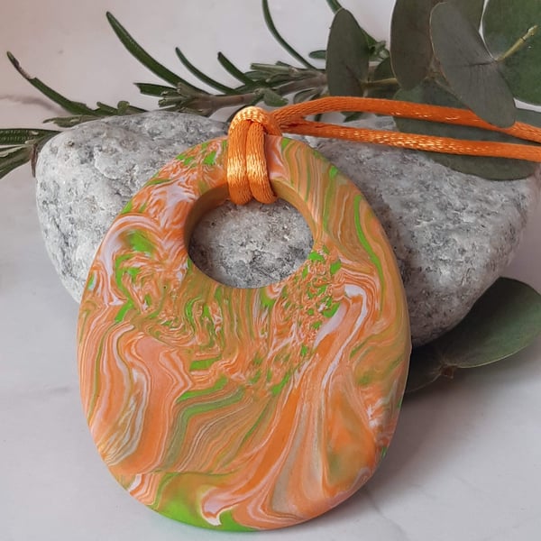 Large handmade oval pendant in orange, peach and lime green polymer clay