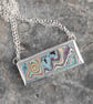 Blue and peach graffitite pendant