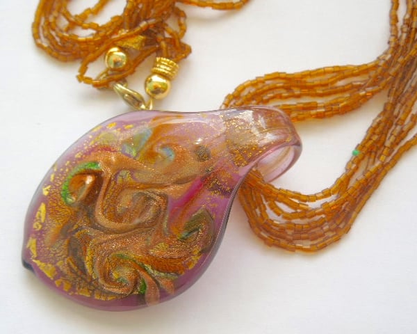 Murano glass brown and gold pendant with beaded strands.