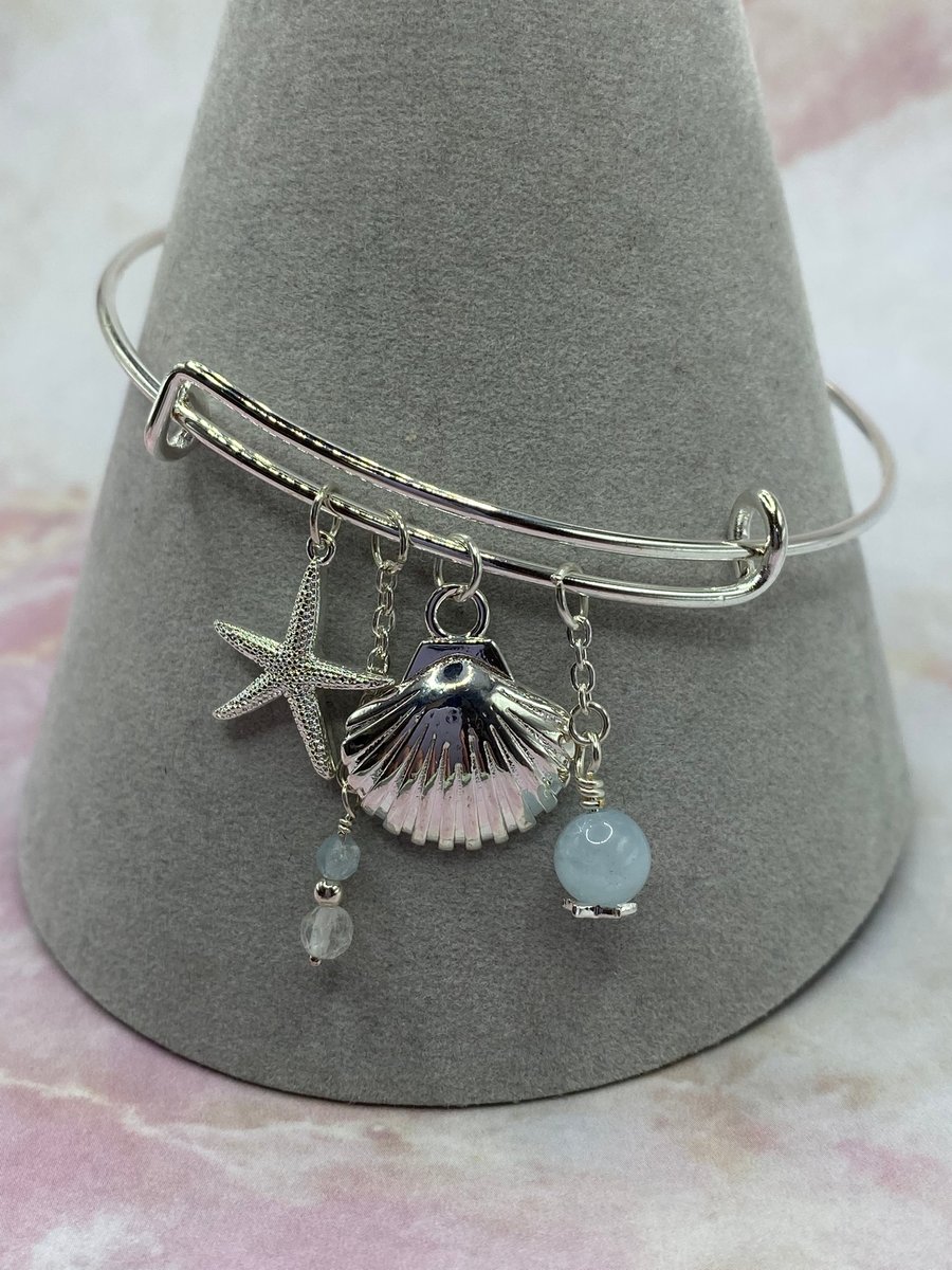 Silver plated charm bangle with aquamarine and topaz stones