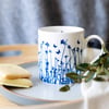 Fine bone china blue butterflies silhouetted over meadow mug