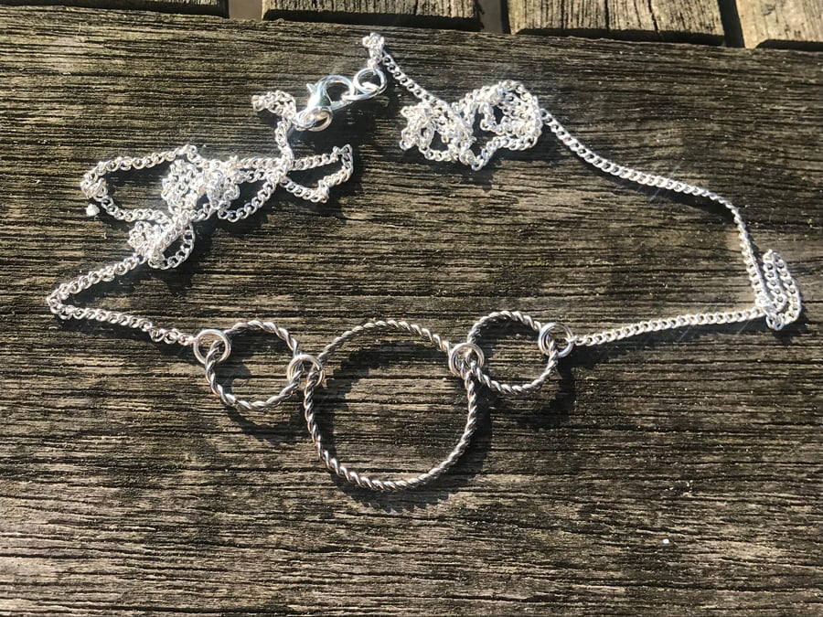 Silver plated twisted triple hoop necklace