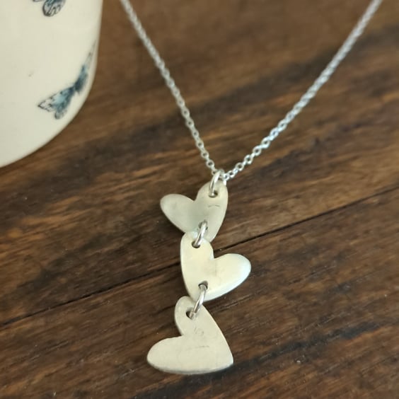 Silver pendant with three heart design