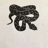 Adder, linocut print of a black snake on handmade paper