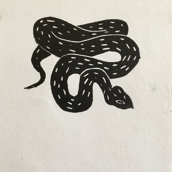 Adder, linocut print of a black snake on handmade paper.