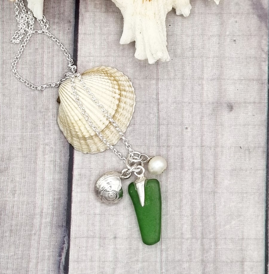 Real shells coated in silver with sea glass and bead, unique item!