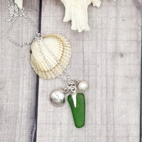 Real shells coated in silver with sea glass and bead, unique item!