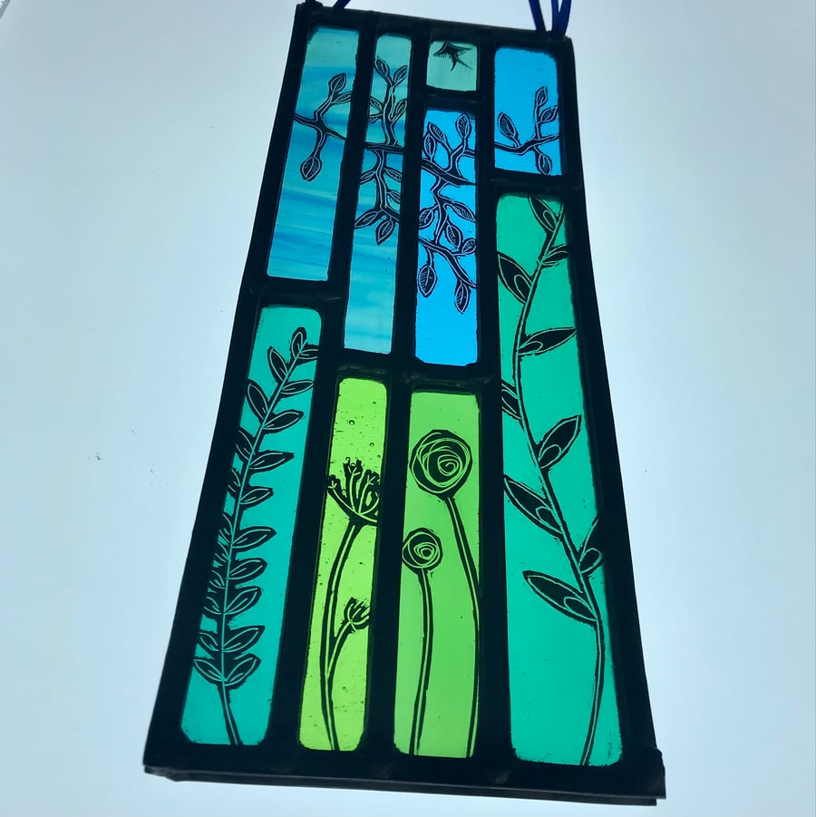 Stained glass panel inspired by the countryside, featuring wildflowers and trees