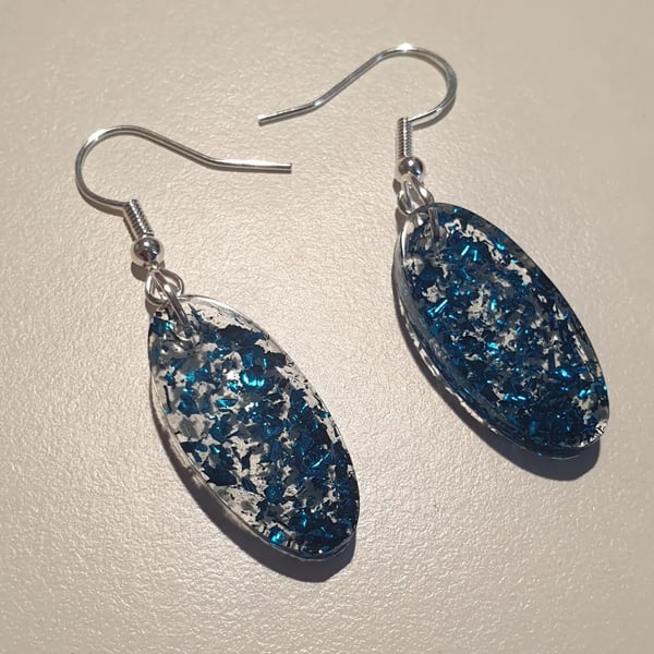 Oval blue metallic flakes resin earrings
