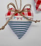 Pair hanging heart decorations on a seaside theme - Image 4