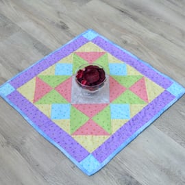 Handmade Quilted table topper with pale spring fabrics and scattered stars.