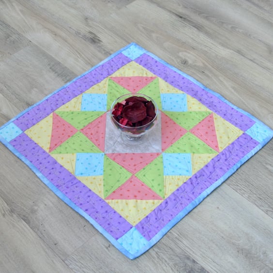 Handmade Quilted table topper with pale spring fabrics and scattered stars.
