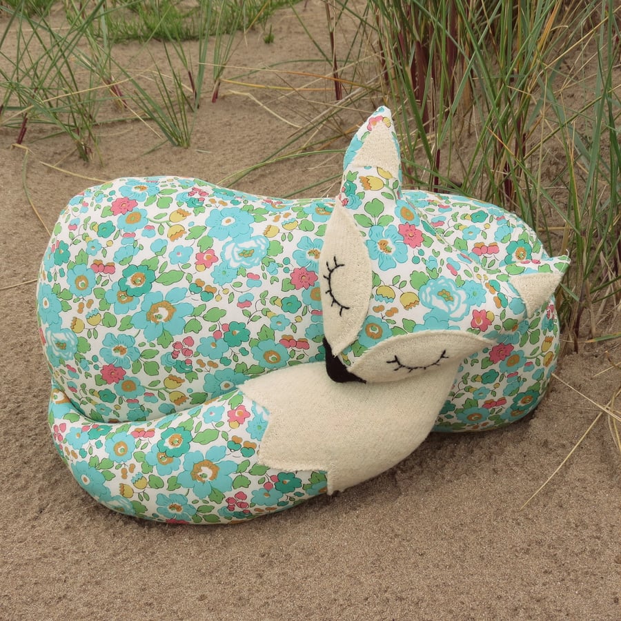 A snoozy fox cushion, made from a floral Liberty Lawn.