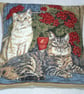 A ginger cat and tabby cat sitting in the window with pots of geraniums cushion  - Image 1