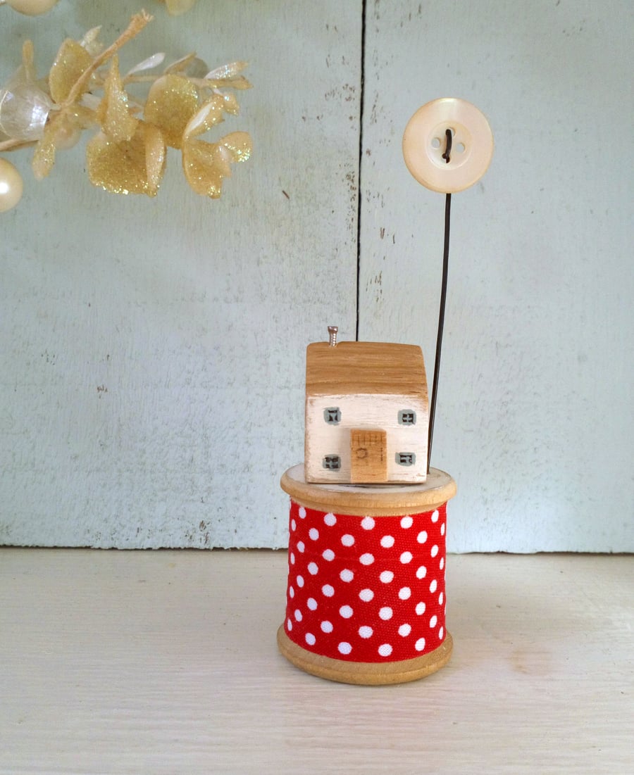 Little wooden house with pearl button on vintage bobbin
