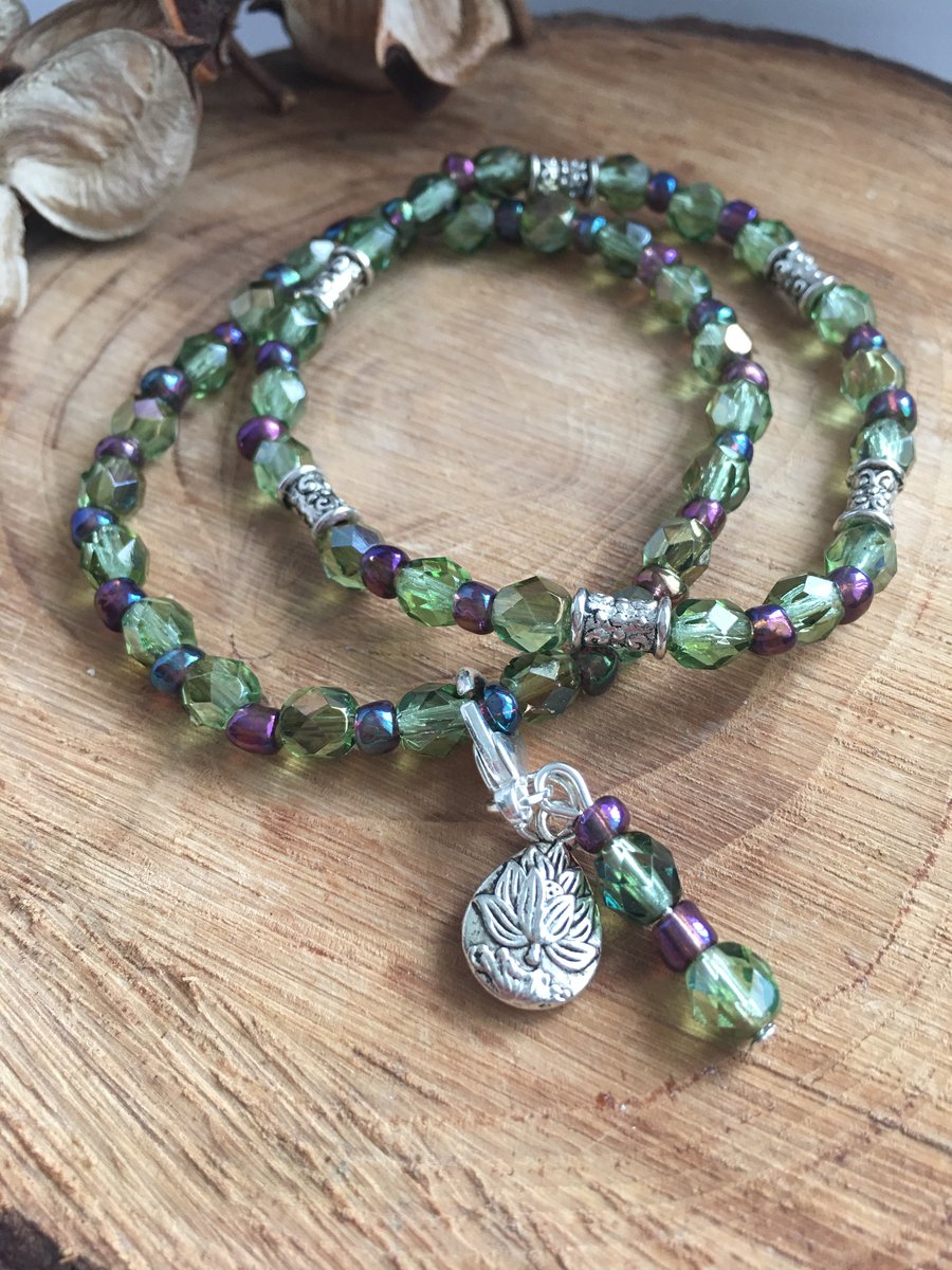 Green Czech glass fire polished bead stretch bracelet with lotus flower charm