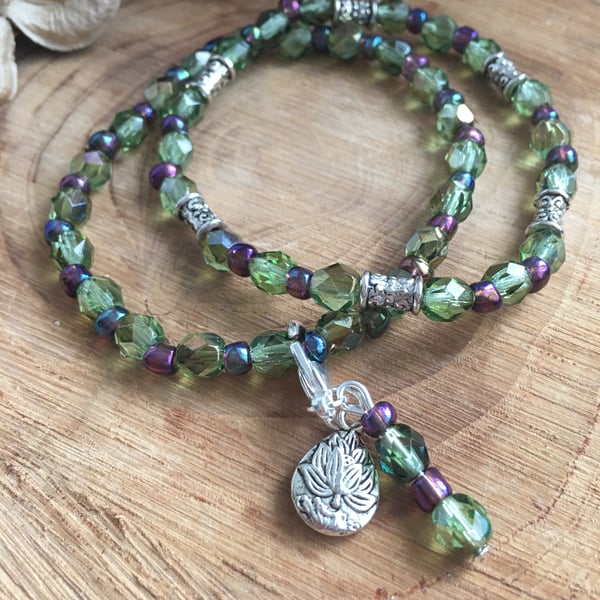 Green Czech glass fire polished bead stretch bracelet with lotus flower charm