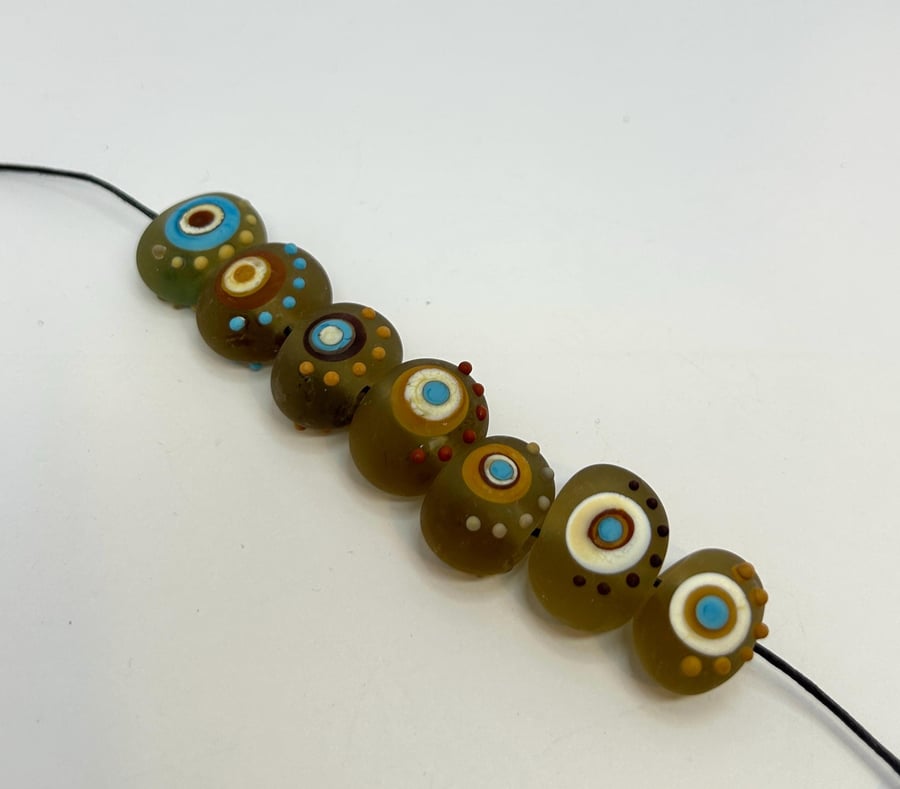 Handmade brown, ivory and turquoise patterned lamp work glass beads