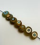 Handmade brown, ivory and turquoise patterned lamp work glass beads - Image 1