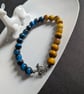 Blue and yellow bracelet with turtle