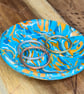 Vibrant turquoise and orange swirly trinket dish