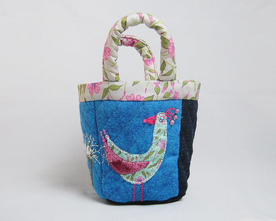 Blue bijou project bag with appliquéd bird and thistle embroidery